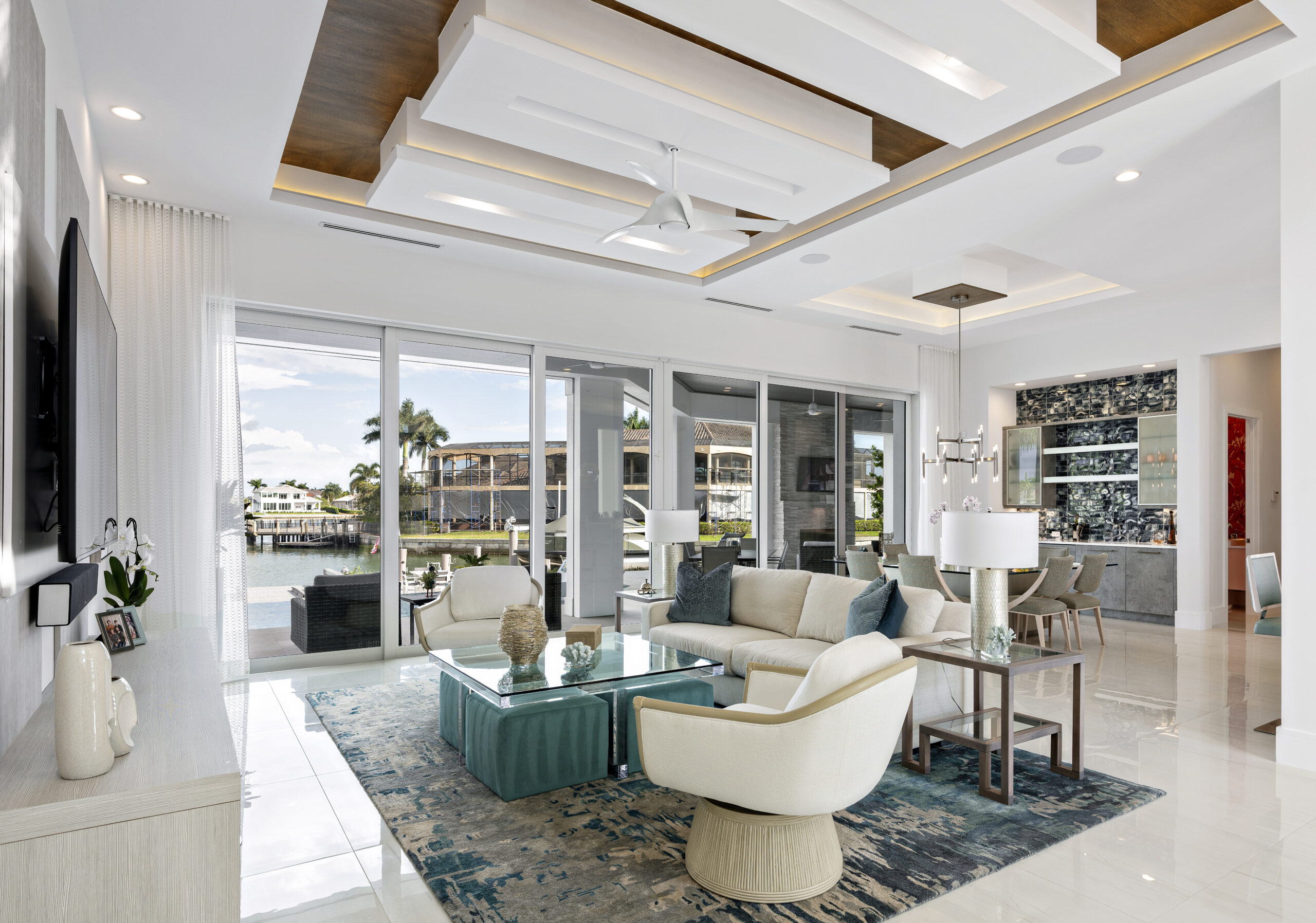 Image of a living room with waterfront views to convey the benefits of using luxury home builders Florida - R.K. Reiman